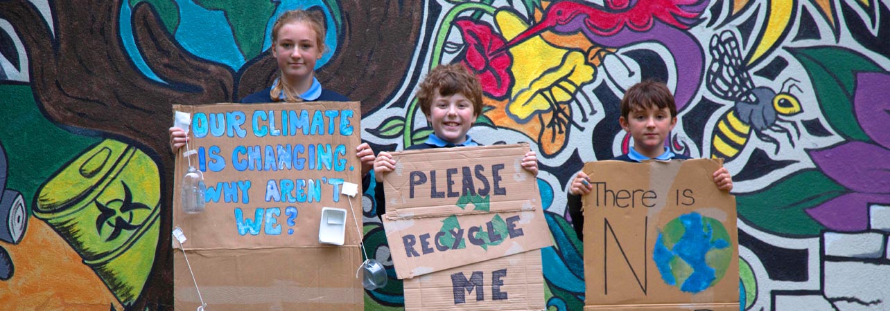Children holding placards reading 'There is no Planet B' and other messages